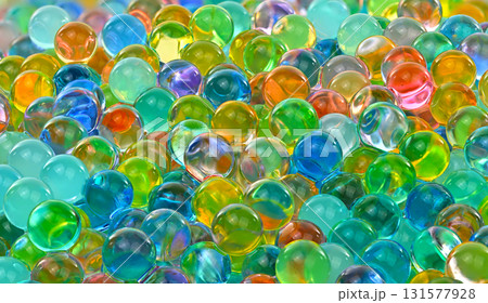 A bunch of colorful marbles are scattered on a surface A bunch of colorful marbles are scattered on a surface 131577928