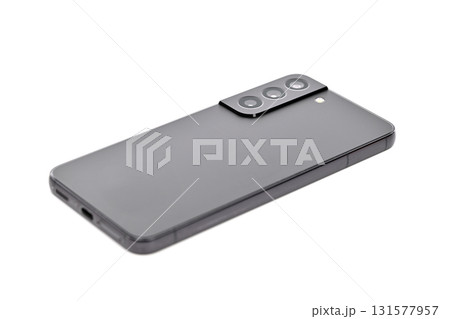 A black cell phone is laying on a white background 131577957