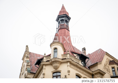 Ornate Roof and Tower of Historic Building with Decorative Elements 131578755