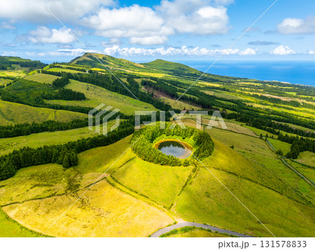 Pond Pau Pique and Lush Green Hills. Atlantic Ocean, Azores, Sao Miguel Island. Portugal. Aerial Pond Pau Pique and Lush Green Hills. Atlantic Ocean, Azores, Sao Miguel Island. Portugal. Aerial 131578833