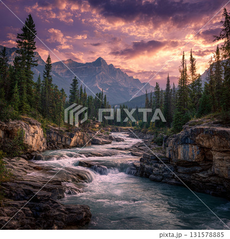 Majestic mountain landscapes at sunset, featuring a rocky river flowing through a forest with pine trees and large boulders. 131578885