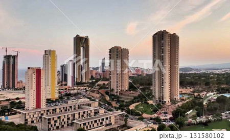Aerial view of a city skyline with tall buildings and a golf course Aerial view of a city skyline with tall buildings and a golf course 131580102