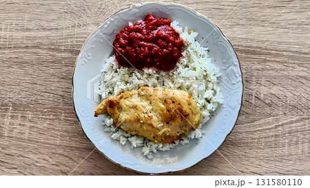 A visually appealing plate of rice, chicken, and flavorful sauces A visually appealing plate of rice, chicken, and flavorful sauces 131580110