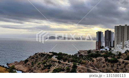 Capture the coastal citys beauty from a cliff, blending nature and city Capture the coastal citys beauty from a cliff, blending nature and city 131580113