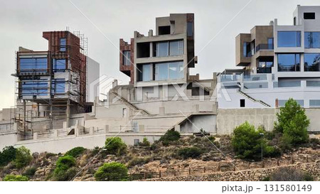 Aerial view of modern houses under construction on a hilltop Aerial view of modern houses under construction on a hilltop 131580149