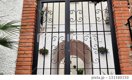 This video shows a wrought iron gate in a charming brick setting This video shows a wrought iron gate in a charming brick setting 131580150