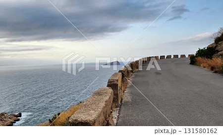 A stunning road descends a cliff, revealing the oceans beauty A stunning road descends a cliff, revealing the oceans beauty 131580162