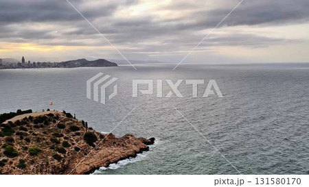 Aerial views of a picturesque city by cliffs and ocean at sunset 131580170