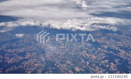 Aerial view of a scenic landscape with beautiful clouds and diverse agricultural fields Aerial view of a scenic landscape with beautiful clouds and diverse agricultural fields 131580240