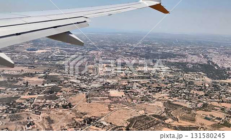 A stunning aerial view seen from an airplane window showcasing a sprawling city landscape A stunning aerial view seen from an airplane window showcasing a sprawling city landscape 131580245