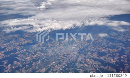 A breathtaking aerial view showcasing diverse landscapes beneath dramatic cloudy skies 131580249