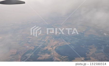 Stunning Aerial Views of a Beautiful Landscape Featuring Clouds and Airplane Wing Stunning Aerial Views of a Beautiful Landscape Featuring Clouds and Airplane Wing 131580314