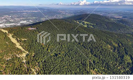 A stunning aerial view of the lush mountains overlooking a scenic landscape with adventure A stunning aerial view of the lush mountains overlooking a scenic landscape with adventure 131580319