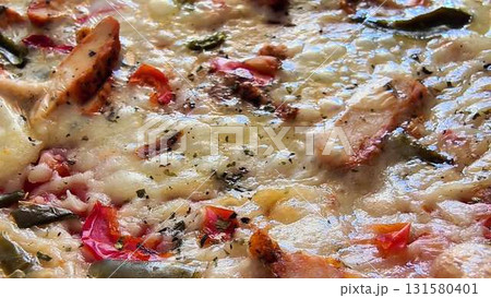 A Mouthwatering and Delicious CloseUp View of a Pizza Topped with Fresh Ingredients and Cheese A Mouthwatering and Delicious CloseUp View of a Pizza Topped with Fresh Ingredients and Cheese 131580401
