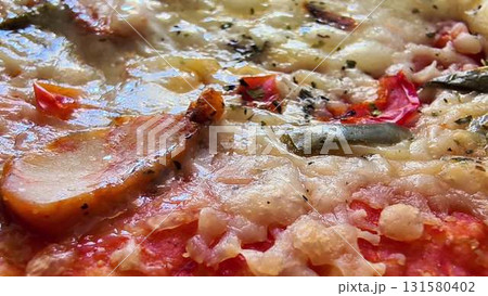 A Mouthwatering Closeup View of Savory Pizza with Tasty and Colorful Toppings On It 131580402
