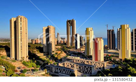 A stunning and modern cityscape featuring tall skyscrapers against a beautiful blue sky A stunning and modern cityscape featuring tall skyscrapers against a beautiful blue sky 131580432