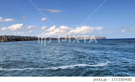 A beautiful coastal view with clear blue waters and a stunning backdrop that brings tranquility 131580480