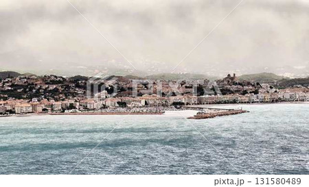 Enjoy a breathtaking view of a serene seaside town with a picturesque pier and stunning scenery Enjoy a breathtaking view of a serene seaside town with a picturesque pier and stunning scenery 131580489