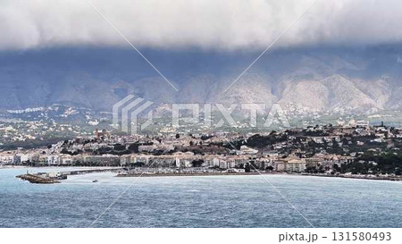 Coastal City Beautifully Set Against Dramatic Skies Full of Color and Movement Above 131580493