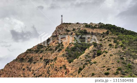 A breathtaking scenic hilltop features a communication tower overlooking the landscape below 131580498