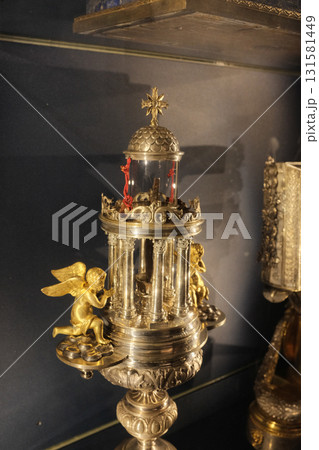 Treasury reliquaries at Basilica of the Holy Cross in Jerusalem Rome gold monstrance cross and sacred vessels in glass display case museum interior editorial use only. High quality photo 131581449