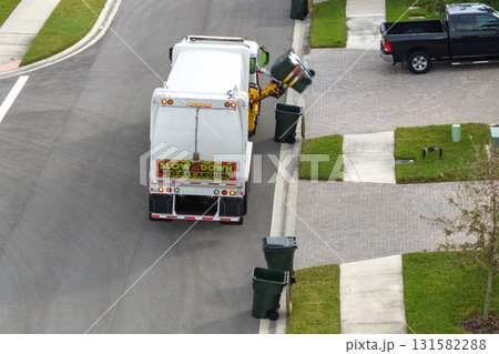 Automated modern garbage collector truck loading waste on Florida town street. Municipal services 131582288
