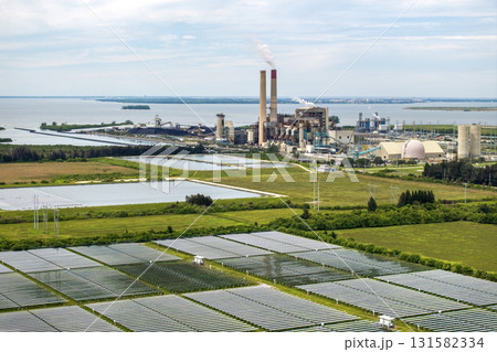 Aerial view of sustainable energy development at Florida Big Bend Power Station. Solar panels symbolize the shift from traditional fossil fuels to clean, emission-free electricity production Aerial view of sustainable energy development at Florida Big Bend Power Station. Solar panels symbolize the shift from traditional fossil fuels to clean, emission-free electricity production 131582334