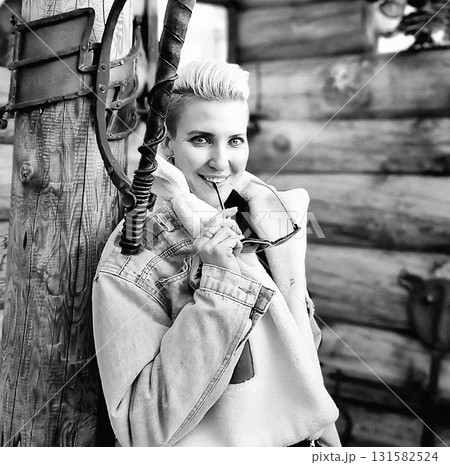 Smiling Woman in Denim Jacket Outdoors Smiling Woman in Denim Jacket Outdoors 131582524