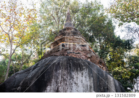 The boulder with the small chedi on top located in Wat Phrathat Pha Ngao temple in Chiang Saen district in Chiang Rai province of Thailand. 131582809