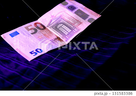 Money. 50 euro banknote on dark blue fabric with lurex Money. 50 euro banknote on dark blue fabric with lurex 131583386