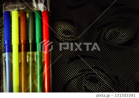 Set of multicolored felt tip pens markers for drawing on dark spotted fabric 131583391