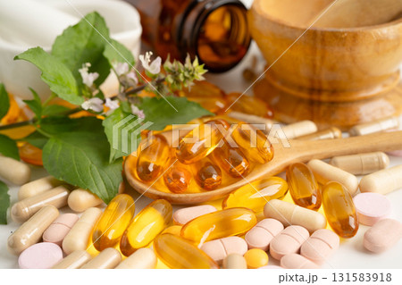 Alternative medicine herbal organic capsule with vitamin E omega 3 fish oil, mineral, drug with herbs leaf natural supplements for healthy good life. 131583918