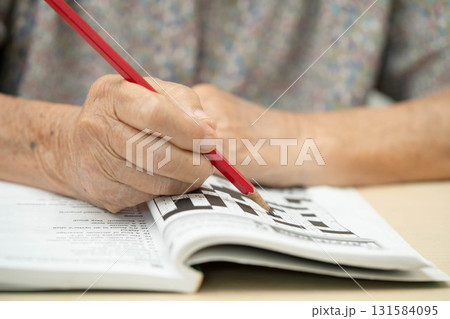 Bangkok, Thailand - May 15, 2022 elderly woman playing sudoku puzzle game. 131584095