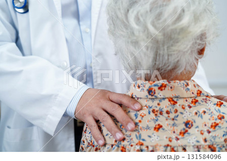 Doctor taking care, help and encourage Asian elder senior woman patient in clinic hospital. 131584096