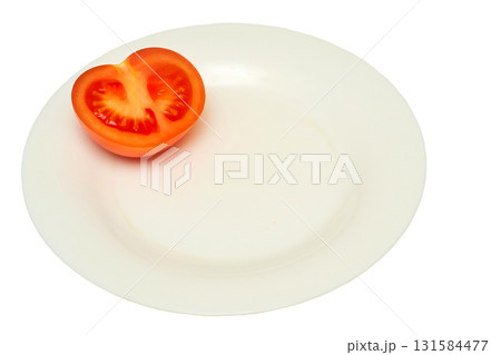 Half of a cut ripe tomato on a white plate. Ready to eat 131584477