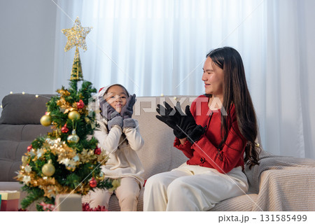 Christmas family home child parent decorate holiday gifts, sharing joyful Christmas moments, embracing warm festive spirit, creating cheerful memories together at home. Christmas family home child parent decorate holiday gifts, sharing joyful Christmas moments, embracing warm festive spirit, creating cheerful memories together at home. 131585499