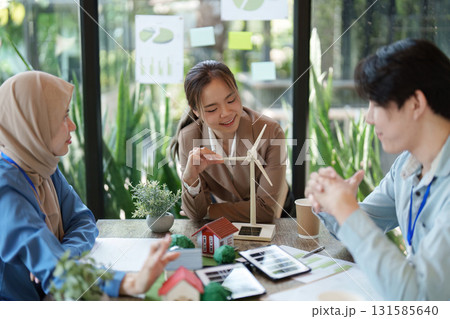 Eco-Friendly Business Practices and Renewable Energy. A team discussing wind energy solutions during a project meeting. 131585640