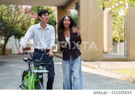 Sustainable Living and Urban Mobility. Two friends enjoying a walk while promoting eco-friendly transportation choices. Sustainable Living and Urban Mobility. Two friends enjoying a walk while promoting eco-friendly transportation choices. 131585654