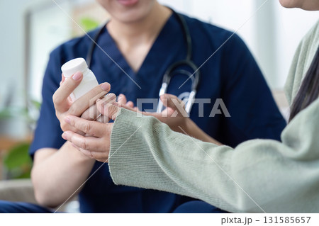Medication Guidance and Patient Care. A nurse hands a patient information about their medication, promoting safety and knowledge. Medication Guidance and Patient Care. A nurse hands a patient information about their medication, promoting safety and knowledge. 131585657