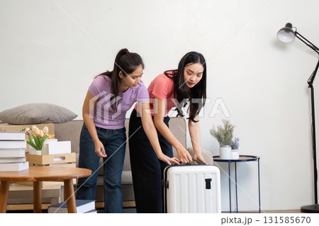 Moving and Packing Together. A couple prepares to pack their luggage, showing teamwork and anticipation for their new adventure. 131585670