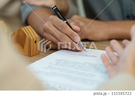 Client signing a real estate agreement, showcasing the commitment to a property deal. Client signing a real estate agreement, showcasing the commitment to a property deal. 131585722