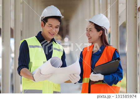 Sustainable construction collaboration. Two engineers discussing project plans on a construction site. Sustainable construction collaboration. Two engineers discussing project plans on a construction site. 131585974