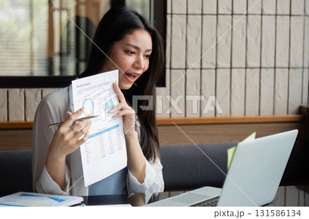Business professional discussing budget analysis via video call, showcasing financial insights. Business professional discussing budget analysis via video call, showcasing financial insights. 131586134