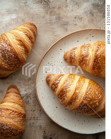 Delicious croissants on a plate bakery food photography cozy setting close-up culinary delight 131586858