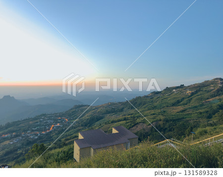 houses on the mountain with stunning view of mountain and cloudy sky 131589328