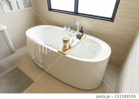 white freestanding tub in new luxury home bathroom. 131589539