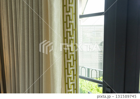 Close up of a curtain with gold trimmings in a luxury mansion. 131589745