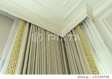 Close up of a curtain with gold trimmings in a luxury mansion. 131589746