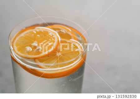 organic lemonade in tumbler glass on concrete background organic lemonade in tumbler glass on concrete background 131592830