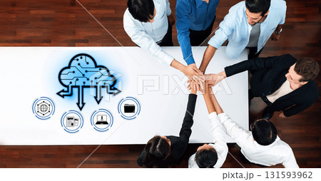 Team Collaboration in Innovative Cloud Computing Solutions with Hands Together on Table in Modern Workspace with Digital Icons Representing Technology Trope 131593962